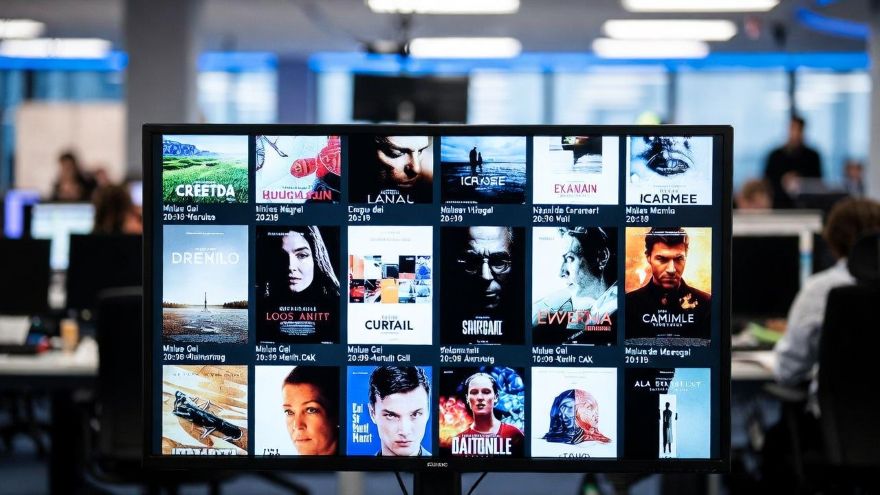 television newsroom screen displaying international film posters